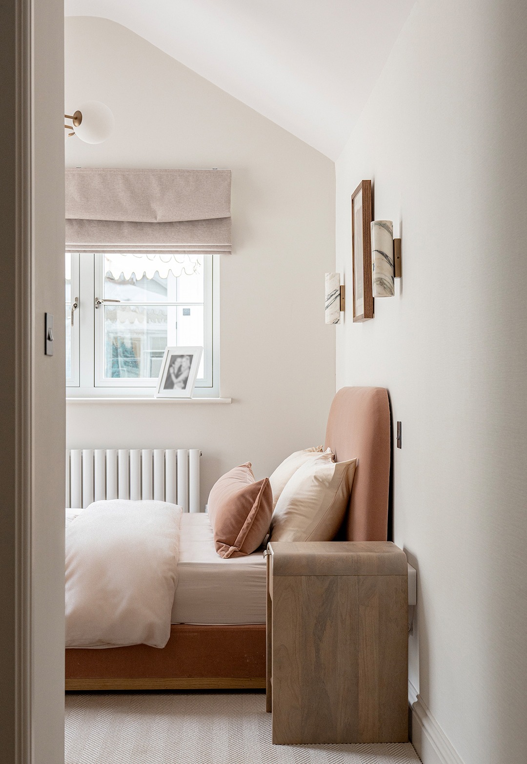 SE1, South East London – Interior design for a show apartment styled for property developers, featuring a cosy bedroom corner with ambient lighting and a side table. Bedding by The White Company and West Elm.